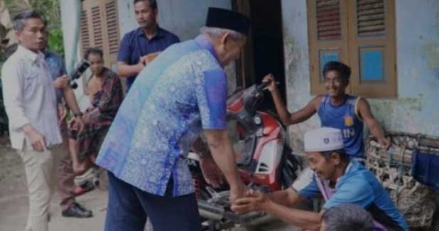 Penjabat Bupati Kampar, Kamsol serahkan bantuan pada masyarakat kurang mampu di Rumbio Jaya.