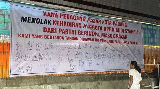 Spanduk penolakan masuk pasar yang dipasang pihak tertentu.