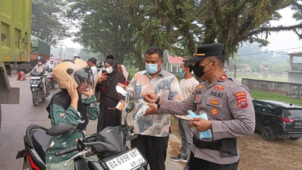 Pemerintah Nagari Sungai Dareh bersama TNI-Polri dan petugas kesehatan Puskesmas Sungai Dareh membagikan masker kepada warga, terutama pengendara sepeda motor yang melintas di Jalan Lintas Sumatera.